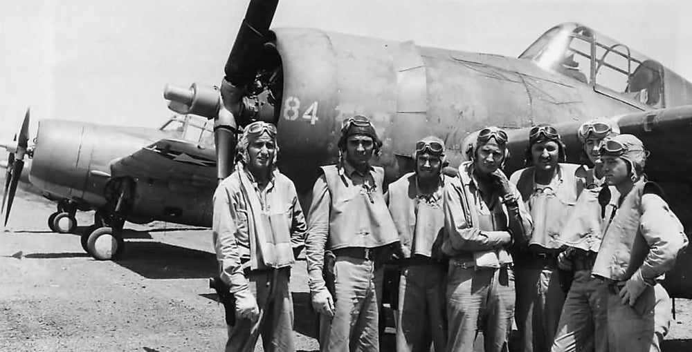 Navy pilots wearing "Mae West" life preservers.