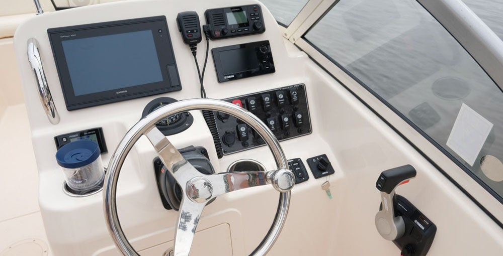 The helm console offers storage in its base, and a wide dash with space to flush-mount multi-function displays of up to 12 inches.