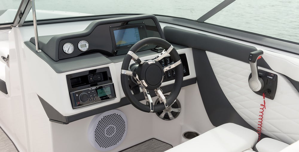 If anyone gets spoiled in this boat, it's the driver with an elegant dash, a beefy padded steering wheel and even power steering.
